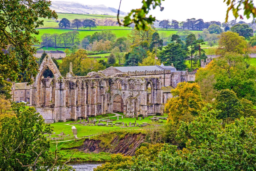 Bolton Abbey seen through the trees from across the River Wharfe