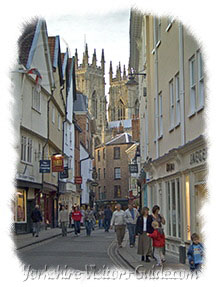 Picture of Petersgate in York. York Minster, whose soaring spires dominate the skyline, is dedicated to Saint Peter.